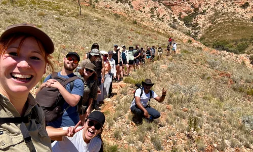 Hikers explore The Pound at Ormiston Gorge.