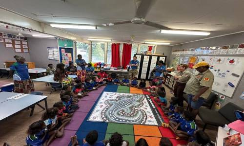 Addressing Murrupurtiyanuwu Catholic Primary School (MCPS) students (standing in front of screen, Tiwi Ranger, Stanley Tipungwuti , seated to Stanley’s left are, from left: John Wilson (Tiwi elder), Lorenzo Kerinaiua (Tiwi Ranger), and Marilyn Kerinaiua (Tiwi elder).